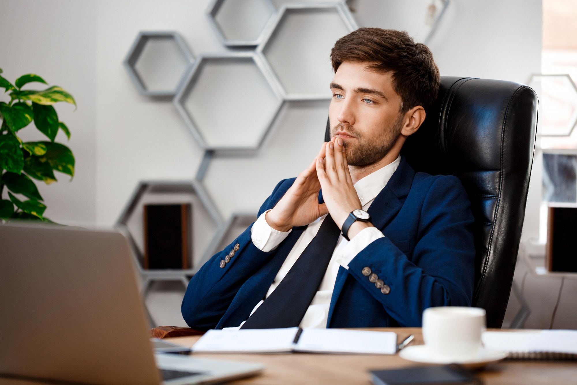 man at desk contemplating